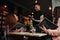 Young women placing order to a waiter at cafe