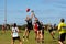 Young women playing Australian Rules Football