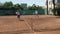 Young women playing doubles at a tennis court