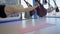 Young women practice anti gravity yoga in hammock in studio.