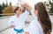 Young women practising karate outdoors on terrace.