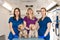 Young women professional pet doctors posing with yorkshire terriers inside pet ambulance. Animals healthcare concept