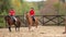 Young women riding horses at farm.