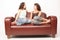 Young women sitting on sofa and talking