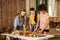 Young women standing at table and cutting fresh vegetables on porch