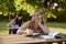 Young women studying with textbook for college exams at school