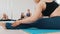 Young women training sitting on the yoga mat - stretching their legs