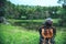 Young women travel nature. she sat on the waterfront lawn at the public park Photographing beautiful landscape