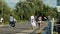 Young women walk along pedestrian track in green city park