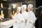 Young women in white bathrobe in bathroom at a spa party