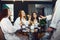 Young women in white bathrobe with champagne glasses at a spa party