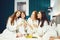 Young women in white bathrobe with champagne glasses at a spa party