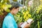 Young women write note among orchid garden. Colorful orchids, Orchid flower bloom