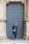 Young wonan poses in front of the Santa Maria de Montserrat Abbey, Catalonia, Spain.