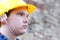 Young worker against the blurred brick wall