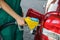 Young worker refueling car at modern gas station, closeup