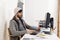 Young worried businessman in cool hipster beanie look looking desperate having problem working in stress