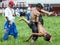 A young wrestler raises his opponent skywards during competition at the Kirkpinar Turkish Oil Wrestling Festival in Edirne in Turk