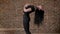 Young yoga girl is training, sport conception, brick background