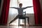 Young yoga woman doing warrior pose using chair.