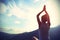 Young yoga woman at sunrise mountain