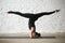 Young yogi attractive woman doing salamba sirsasana pose with sp