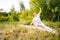 Young yogi woman practicing yoga on park outside the city. Meditative lady enjoying meditation