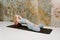 Young yogini practicing Matsyasana pose in pastel blue leggins and top