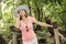 Young youful woman with sunhat posing in green forest