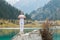 Young zen man in meditation. Outdoor yoga in mountain lake