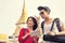 Younger asian tourist holding guide book standing in traveling d