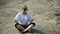 Younger woman doing yoga on rocky landscape of Safari