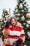 Younggirl on the red Square through winter holiday in Moscow, stylish and beautiful posing near to Christmas tree