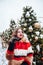 Younggirl on the red Square through winter holiday in Moscow, stylish and beautiful posing near to Christmas tree