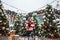 Younggirl on the red Square through winter holiday in Moscow, stylish and beautiful posing near to Christmas tree