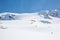 Youngs Peak above backcountry skier skinning uphill toward the Seven Steps of Paradise ski line