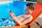 Youngster operating mobile phone at swimming pool