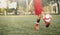 Youngster playing with soccer ball on field