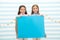 Your advertisement in good hands. Girls kids hold advertisement poster copy space. Children hold advertising banner