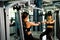 your arms with this arm exercise machine. healthy women exercise in fitness gym