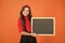 For your attention. Happy girl hold blackboard orange background. Small kid with blank blackboard. Little schoolchild