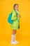 On your back and ready to go to school. Little school girl wear cute raincoat on yellow background. Adorable kid with