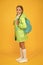 On your back and ready to go to school. Little school girl wear cute raincoat on yellow background. Adorable kid with
