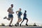 Your body will only move if you make it move. three athletic young men out for a run together.