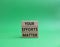 Your Effort Matter symbol. Wooden blocks with words Your Effort Matter. Beautiful green background. Business and Your Effort