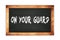 ON  YOUR  GUARD text written on wooden frame school blackboard