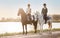 Your mind wanders as you explore country lanes. two young women out horseback riding together.