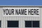 Your Name Here banner on the exterior of a vacant building for lease or rent I