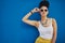 When your pout is on point. Shot of an attractive young woman wearing funky sunglasses against a blue background.