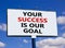 Your success is our goal symbol. Words `your success is our goal` on white billboard. Beautiful blue sky. Beautiful background,